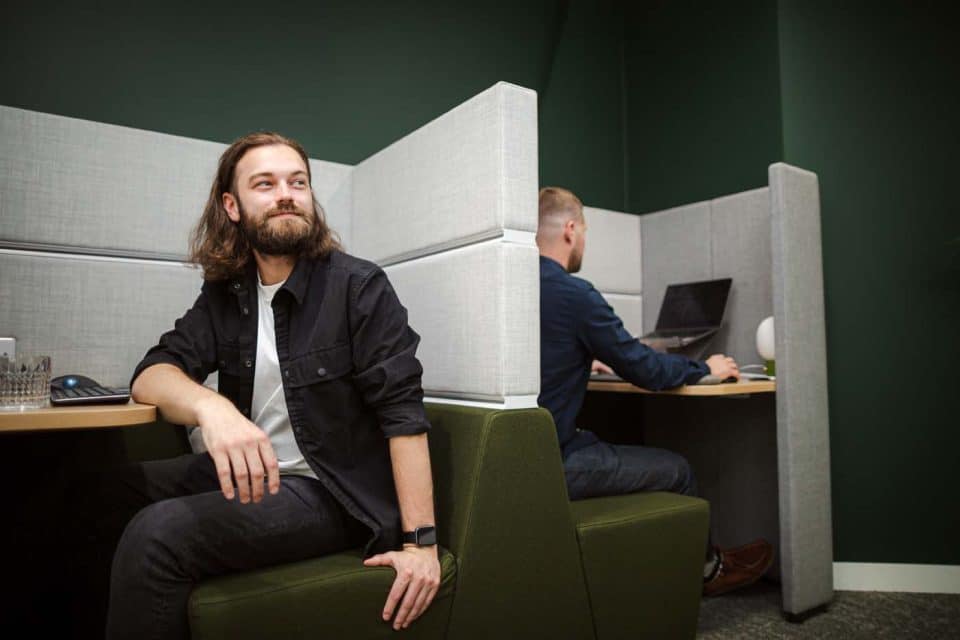 Acoustic pod in Manchester providing a quiet workspace, showing office workers using enclosed seating to support focus, privacy, and reduced noise distraction.