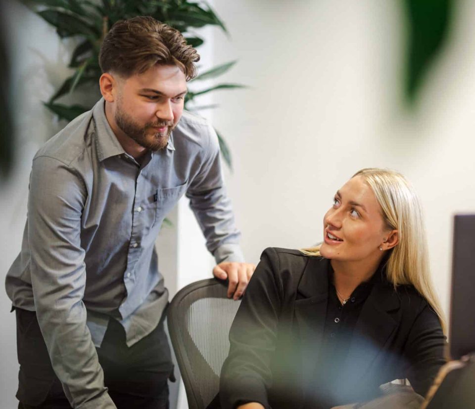 Workplace Culture image showing colleagues engaged in a supportive one to one conversation, demonstrating trust, collaboration, and inclusive ways of working.