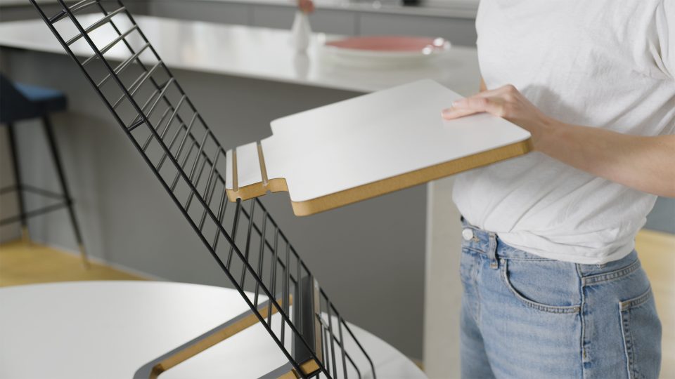 Mousetrapper standfriend in use with a laptop set up. close up image of keyboard platform being placed within the unit