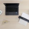 full desktop showing a laptop, and some mathematical tools, the IRIScan Executive 4 Duplex scanning a page of text