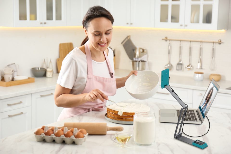 IRIScan Visualizer 7 being used in a kitchen environment as a recording device. woman in image is in baking clothes, baking a cake. eggs are shown in the foreground