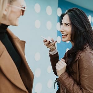 two people using the Pocketalk device to interact with each other