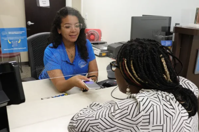 Pocketalk being used by two people to interact at a government facility