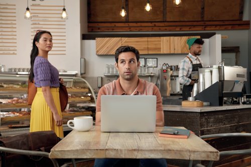 3M Bright Screen Privacy Filter for 14 inch laptop 16:9 used on a laptop in a café, helping protect on screen content from surrounding people.