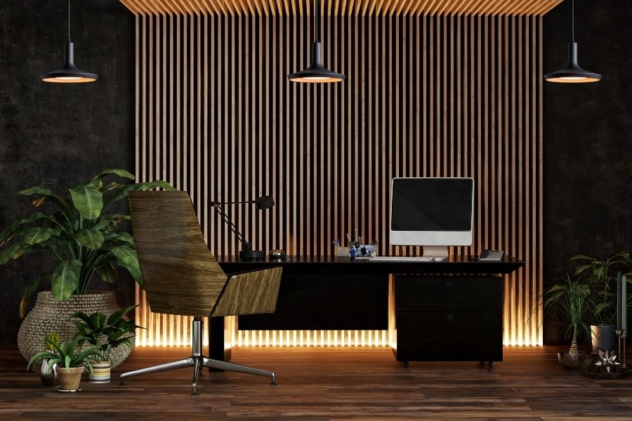 Modern home office with desk, plants, and office ambient lighting.