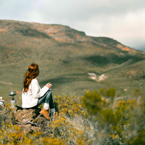 The Neuro Sculpting of Stress blog image person sitting outdoors reflecting on mental wellbeing
