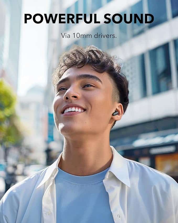 Person wearing a black Soundcore Anker P30i earbud outdoors.