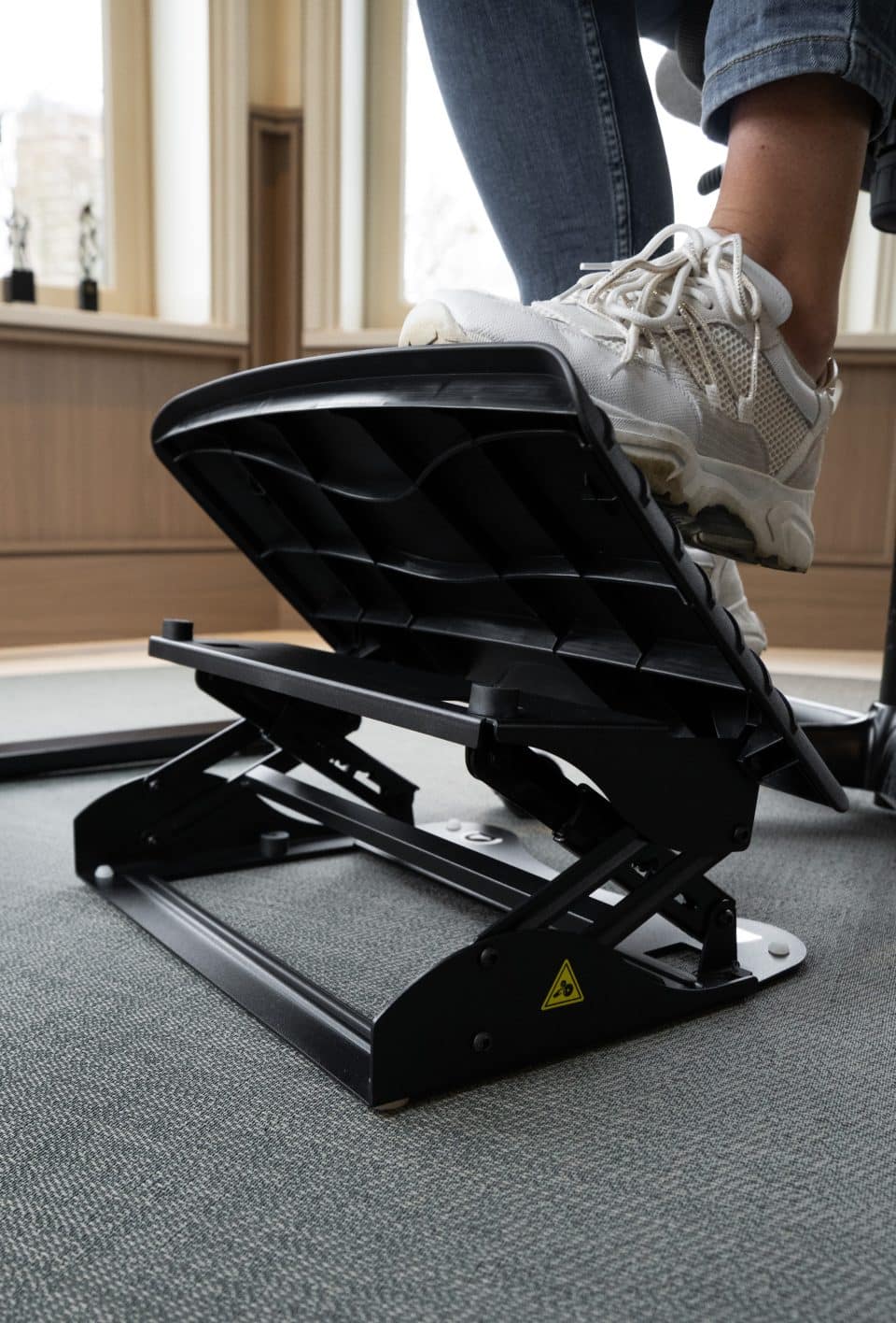 Atlantic Footrest by BakkerElkhuizen being adjusted to a raised angled position using the foot controls.