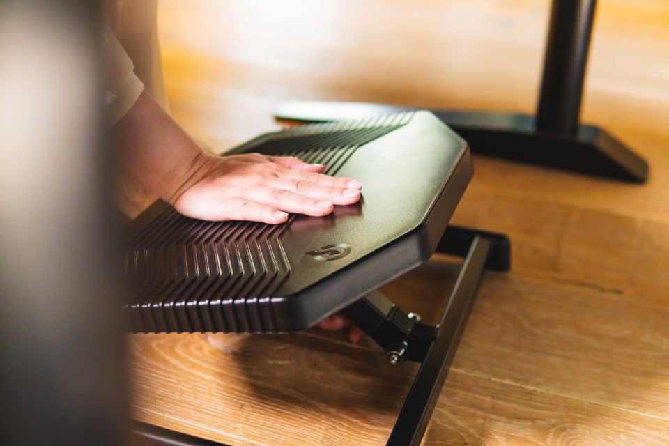 Person adjusting the Basic950 BakkerElkhuizen footrest platform by hand.