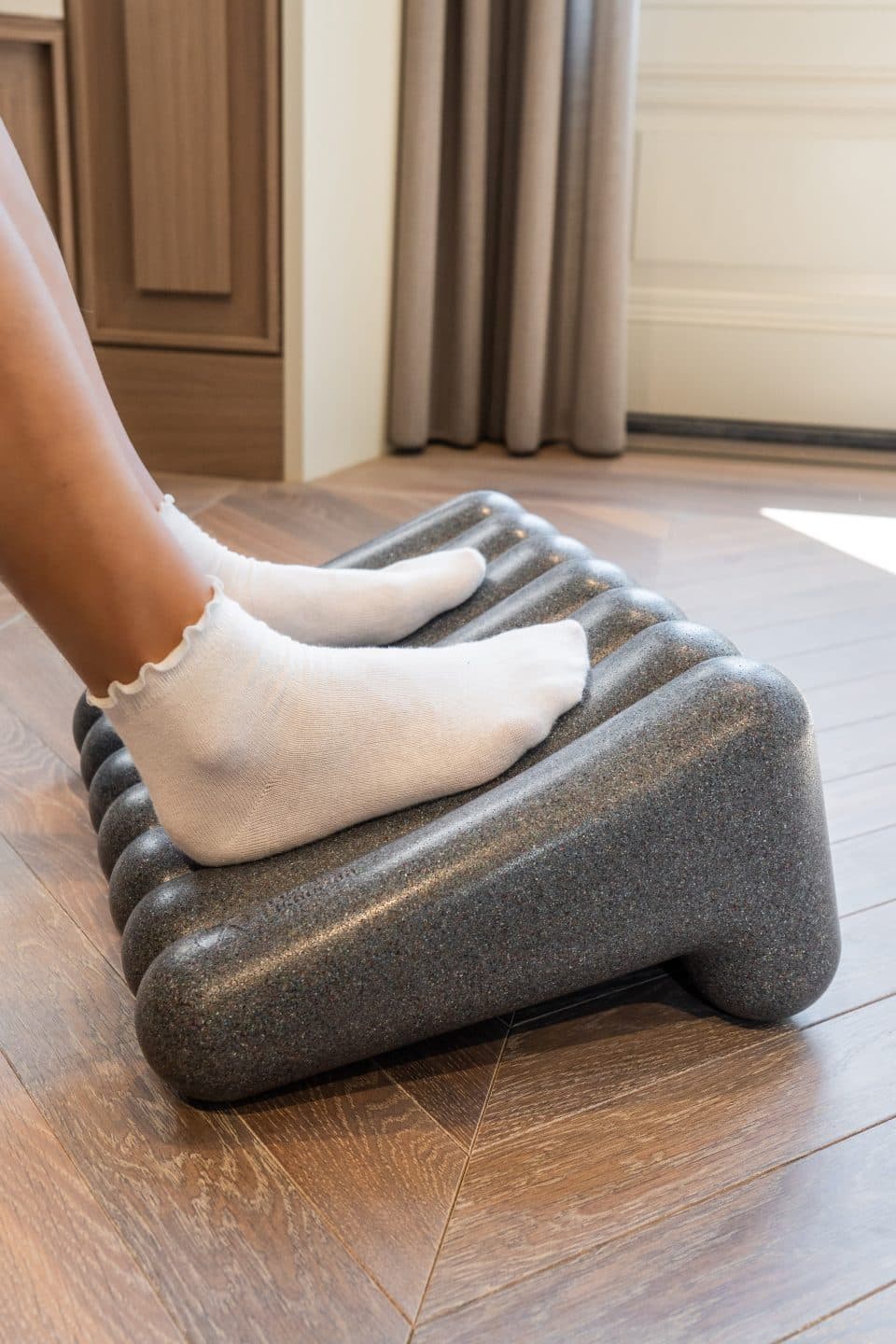 Person resting their feet on the FootRest No.4 by BakkerElkhuizen.