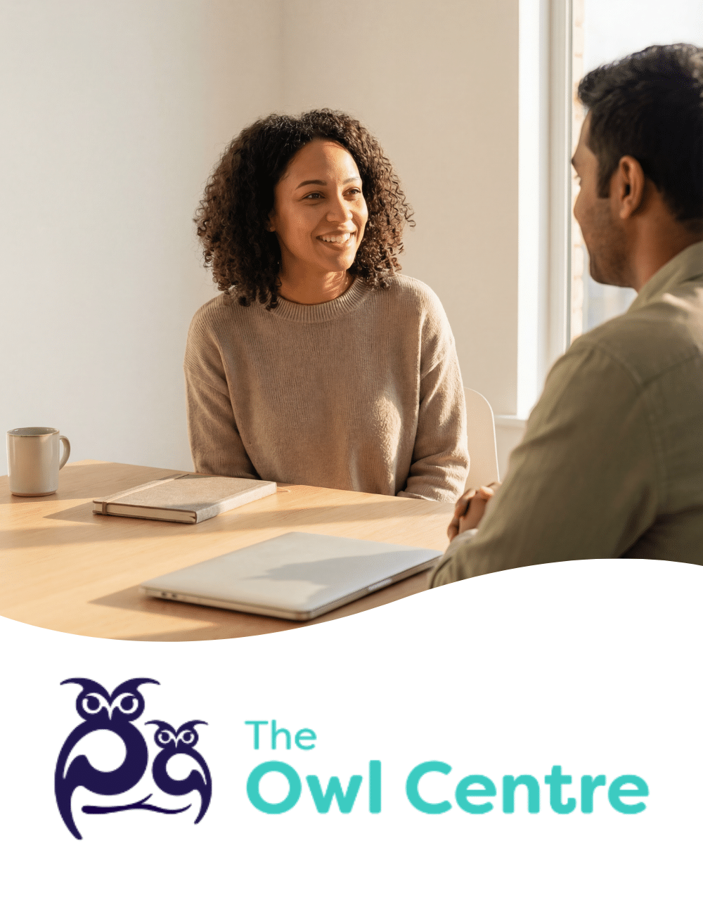 Two people having a friendly conversation across a table, with The Owl Centre branding below.